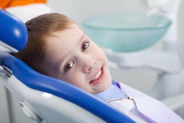 Young child sitting in dental chair in urbandale