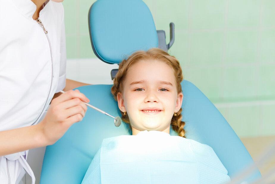 young girl smiling in dental chair at Urbandale dental office