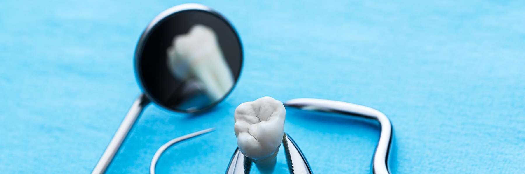 Blue background with dental tools, highlighting dental bridge care.