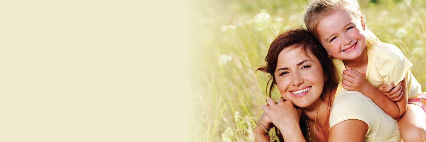 mother and daughter smiling in a Johnston IA field