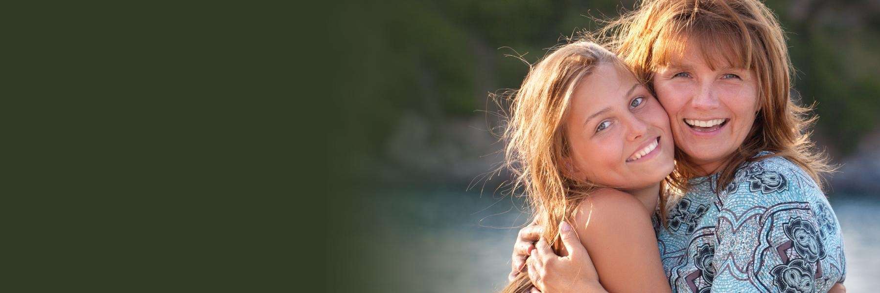 mother and daughter hugging and smiling in Johnston